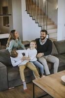 Siblings fighting over TV remote control at home photo