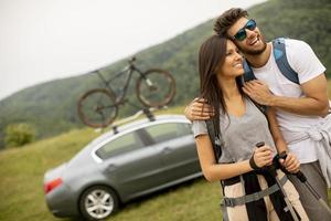 Couple of hikers with backpacks starting a walk through the fields photo
