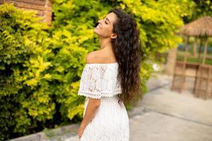 Pretty young curly hair woman in the park photo