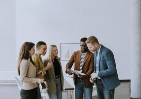 Group of multiethnic business people standing together and preparing new project on a meeting in office photo