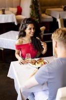 Young couple having lunch with white wine in the restaurant photo