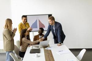 Group of multiethnic business people working together and preparing new project on a meeting in office photo