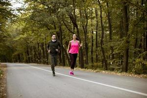 Young people jogging and exercising in nature photo