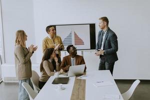 Group of multiethnic business people working together and preparing new project on a meeting in office photo