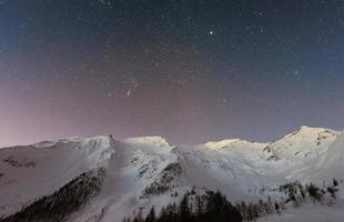 white snow on the mountain covered with evening sky under star nature background