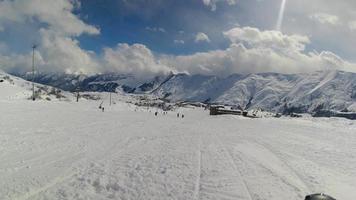 Slow motion cinematic aerial view Ski slopes in Gudauri ski resort with caucasus mountains background. video