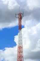 Tall telephone poles are ready to distribute Internet and telephone signals for the public to make full use of them against the background of the beautiful natural afternoon white and blue sky. photo