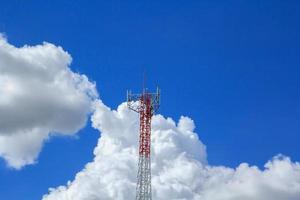 Tall telephone poles are ready to distribute Internet and telephone signals for the public to make full use of them against the background of the beautiful natural afternoon white and blue sky. photo