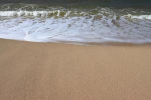 Waves on shore of tropical beautiful sand beach on a sunny day photo