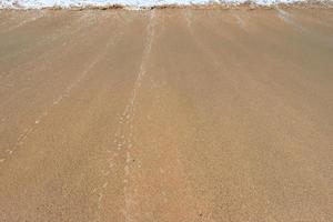 Water foam with smooth sand. photo