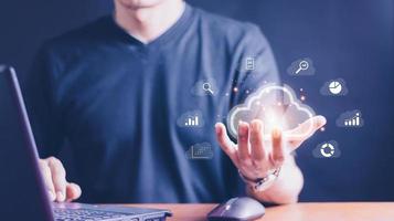 man use Laptop with cloud computing diagram show on hand. Cloud technology. Data storage. Networking and internet service concept. photo