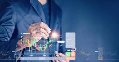 planning analyze indicator and strategy buy and sell, Stock market, Business growth, progress or success concept. Businessman or trader is pointing a growing virtual hologram stock, invest in trading photo