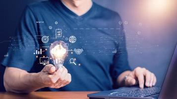Man Hand holding Light bulb Global Internet connection. Business global internet connection application technology and digital marketing, Financial and banking, Digital link tech, big data. photo