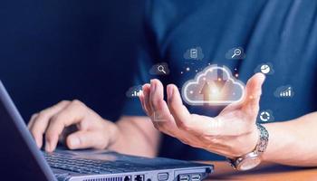 Cloud technology. Data storage. Networking and internet service concept.man use Laptop with cloud computing diagram show on hand. photo