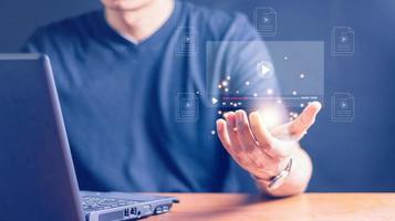 Man using mouse and keyboard for streaming online on virtual screen, watching video on internet, live concert, show or tutorial, content online. photo
