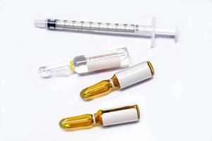 3 ml. brown Ampules of drug and plastic syringe on white background. photo