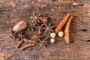 Closeup Dry spices or herbs on old wood background. photo