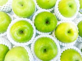 Top view of green apples in net foam full screen background and wallpaper. photo