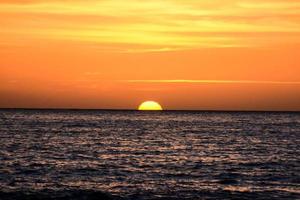 Sunset over the ocean photo