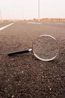 Magnifier glass on the ground photo