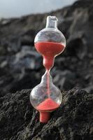 Hourglass on rocks photo