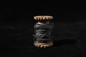 Twine spool on dark background photo