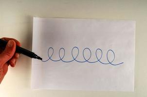 Hand drawing spirals on paper photo