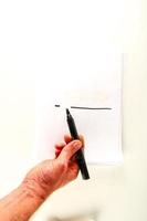 Hand drawing a line on paper photo