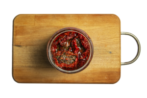 Background of sun-dried tomatoes with spices and salt in olive oil. Top view. png
