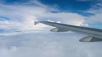 Airplane wing flies past a cloud. Cumulus cloud near the wing. View from the plane window. Beautiful view of the clouds video