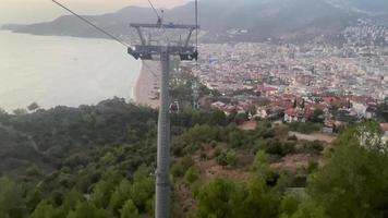 Cable car, monorail funicular for going up and down the mountain for a tourist excursion with a view of the city and the mountain in a tropical paradise resort in an eastern warm country video