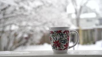 avkopplande och dricka kaffe eller te, den koppar av kaffe på en snö dag, på balkong. avslappning begrepp. suddig bakgrund av skön . video