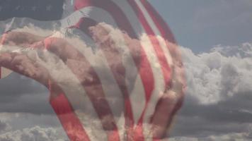 American flag over blue sky with clouds video