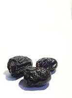 Isolated photo of three ajwa dates. Ajwa dates or also known as Prophetic Dates.