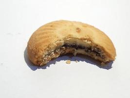 Isolated photo of Maamoul Al Batal cake. Biscuits filled with dates covered in chocolate.