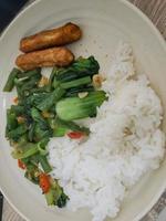 Sauteed chickpeas and pokcoy with fried nuggets and rice. photo