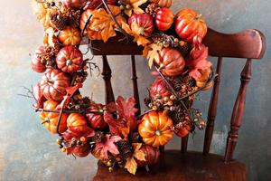 Festive autumn wreath with pumpkin and fall leaves photo