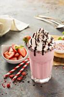 Strawberry milkshake with whipped cream photo