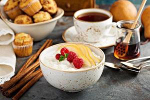 Rice pudding with raspberries and pears for breakfast photo