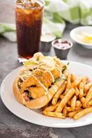 Shrimp po boy sandwich with fries photo