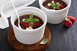 Chocolate pudding with raspberries and basil photo