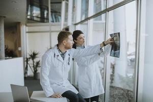 Team of young doctors examining x-ray image in the office photo