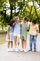 Group of asian and caucasian kids having fun in the park photo