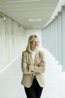 Business woman standing in the office corridor photo