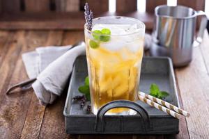 Lavender iced tea in tall glass photo