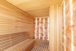 Empty wooden sauna room with traditional sauna accessories photo