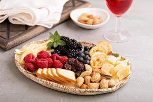 Cheese plate with nuts and berries photo