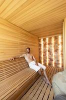 Young man relaxing in the sauna photo