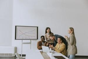 Group of multiethnic business people working together and preparing new project on a meeting in office photo