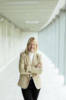 Business woman standing in the office corridor photo